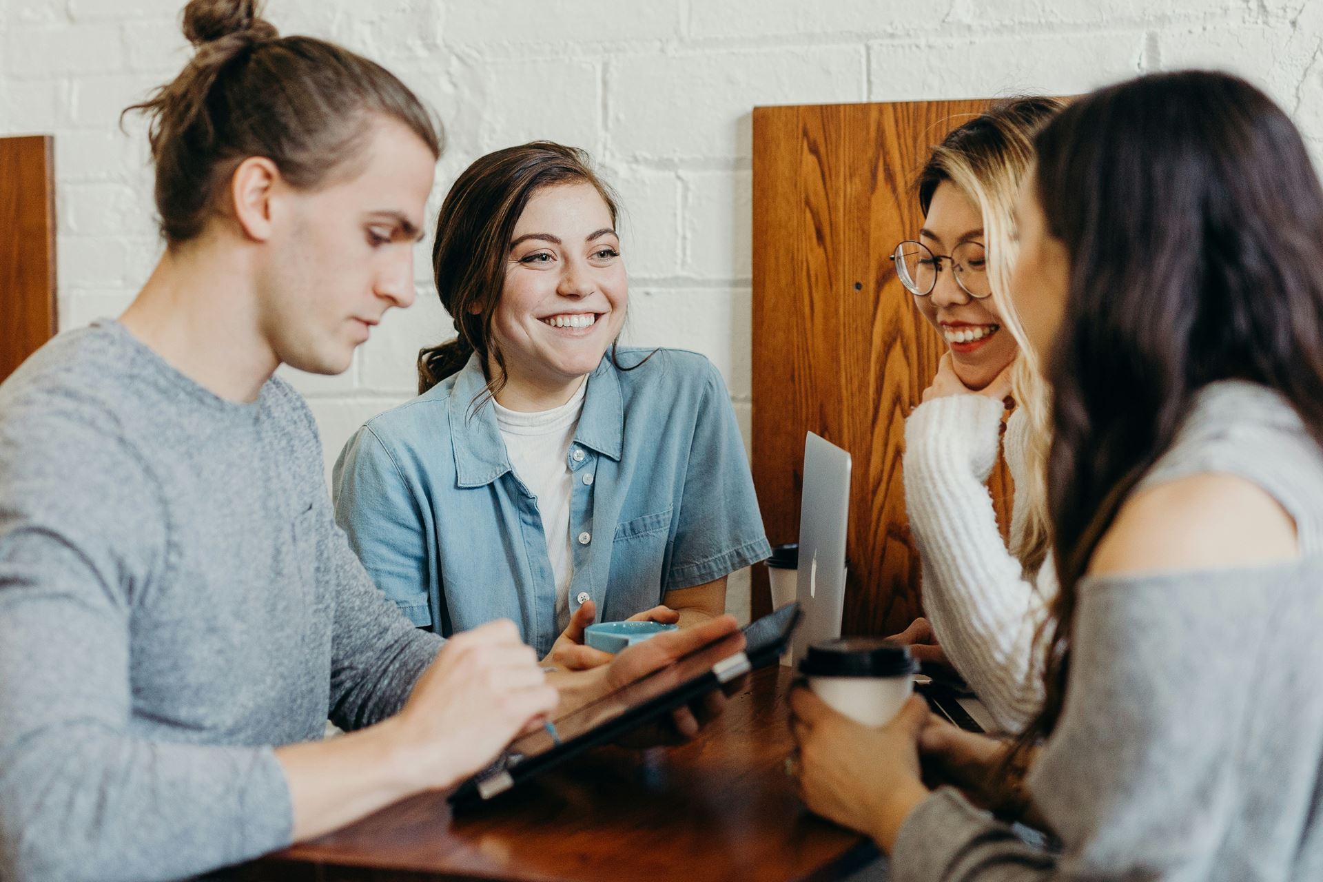 group of four people talking 