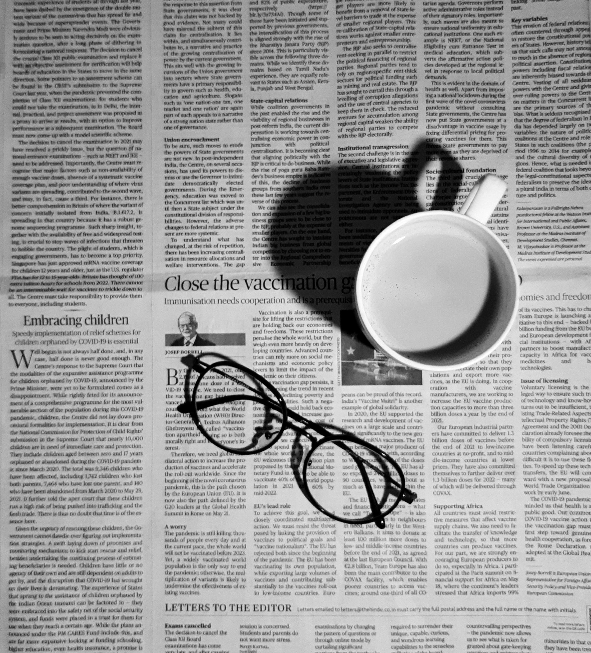 newspaper with coffee cup and glasses